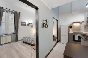 a room with a kitchen and a bedroom with a bed at Cuore di Genova in Genova