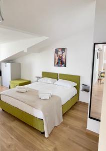 a bedroom with a large bed in a room at Huma BnB in Casapulla