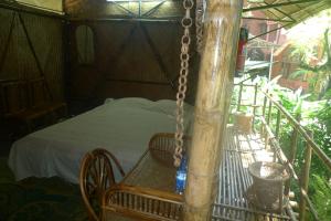 a swing in a room with a bed in it at Hilltop Lodge in Guwahati
