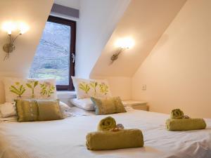 a bedroom with two teddy bears on a bed at Pine Marten Cottage in Ballachulish +9 photos
