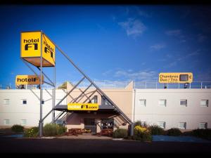a hotel with a sign in front of a building at hotelF1 Cholet in Cholet