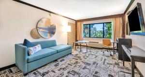 a living room with a couch and a table at Crowne Plaza Hotel Foster City-San Mateo by IHG in Foster City
