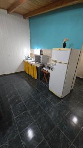 a kitchen with a white refrigerator and a table at Obera Departamento Hasta 4 Personas in Oberá