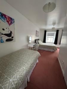 a bedroom with two beds and a window at Central Town House,Moville 61 in Moville