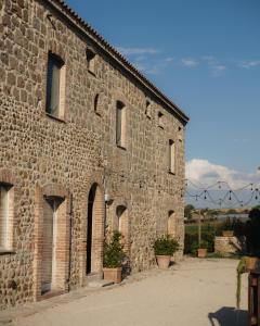 an old stone building with a bunch of windows at Arcadia Agriturismo in San Nicola Manfredi