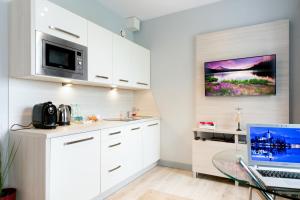 Kuchyňa alebo kuchynka v ubytovaní ActivPark Apartments