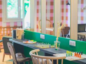 a table with chess pieces on it in a restaurant at greet hôtel Annecy Cran-Gevrier by Accor in Annecy +86 photos