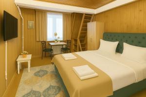 a bedroom with a bed and a table with a chair at Airport 179A in Otopeni