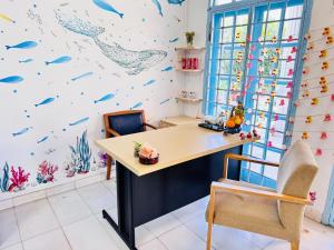 a desk in a room with a mural of fishes at 吉隆坡后花园别墅Backyard Garden Villa KL in Petaling Jaya
