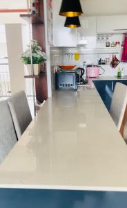 a kitchen with a long table with chairs in it at Oval View Residencies in Colombo