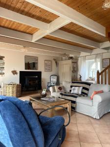 a living room with a couch and a table at Ty Guillerm - Maison bretonne entre terre et mer in Plounévez-Lochrist