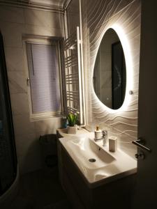 a bathroom with a sink and a mirror at Apartman Relax in Slavonski Brod +44 photos