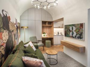 a living room with a green couch and a table at The Botanist by Adrez in Prague