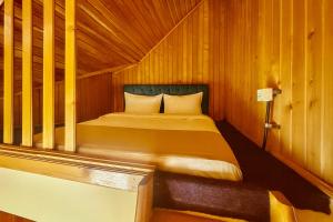 a bedroom with a bed in a wooden room at Airport 179A in Otopeni +10 photos