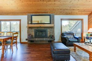 a living room with a fireplace with a tv above it at 3 Spyglass in Sunriver