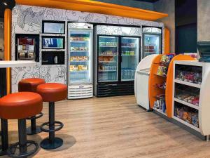 a store with two bar stools and a refrigerator at ibis budget Sao Paulo Paraiso in Sao Paulo