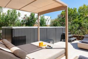 a patio with a table and an umbrella at Le Soleil De Lindos - Luxury Villa with Swim Spa in Líndos +23 photos