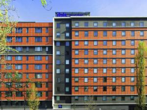 two tall buildings are next to each other at Greet Hotel Paris porte de la Chapelle - Aréna in Paris