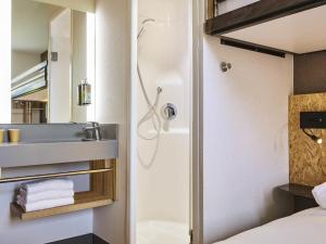 a bathroom with a shower and a sink at Greet Hotel Paris porte de la Chapelle - Aréna in Paris