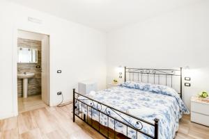 a white bedroom with a bed and a bathroom at Villa Trieste in Venice