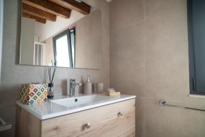 a bathroom with a sink and a mirror at Dimora Lincoln in Grotte +99 photos