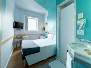 Ένα ή περισσότερα κρεβάτια σε δωμάτιο στο ibis budget Sao Paulo Jardins