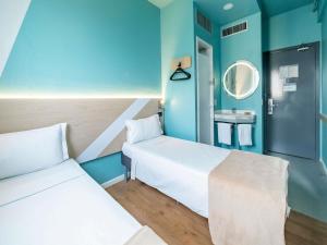 Ένα ή περισσότερα κρεβάτια σε δωμάτιο στο ibis budget Sao Paulo Jardins