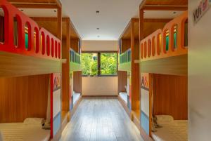 a hallway with four bunk beds in a room at Leng x Vuishare - Ecopark with working space in Kim Quan