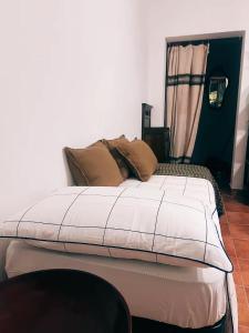 a bedroom with a large bed with brown pillows at La Rosa dei Monti Iblei 1 in Ferla +27 photos