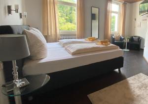 a bedroom with a large bed with a glass table at Hotel W Wolfsschlucht in Baden-Baden