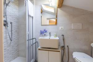 a bathroom with a sink and a toilet and a shower at Italian Experience - Casa La Conchiglia in Porto Recanati +41 photos