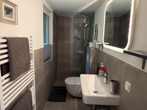 a bathroom with a white sink and a toilet at Ferienhäuschen Möwenschiss, 500m zum Strand in Graal-Müritz +9 photos