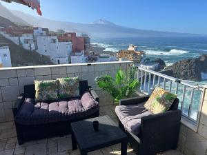 a balcony with two couches and a view of the ocean at WONDERFUL Sea Views El Pris in El Pris