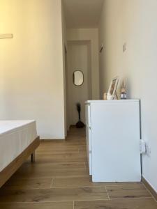 a room with a white refrigerator and a hallway at Casa Amali in Intra +6 photos