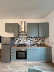 a kitchen with blue cabinets and a stove and a sink at Casa Amali in Intra