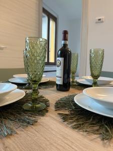 a bottle of wine sitting on a table with glasses at Casa Amali in Intra