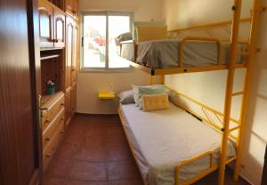 a small room with two bunk beds and a window at WONDERFUL Sea Views El Pris in El Pris