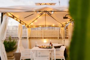 a table and chairs under a tent with lights at Siramà Suite Deluxe in Oria