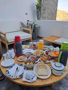 a table with plates of food on it at Sinagoga Guesthouse in Ribeira Grande