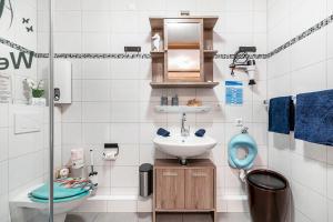 a small bathroom with a sink and a toilet at Kleine Auszeit am Meer in Büsum +13 photos