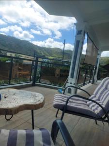 a balcony with a table and chairs and a view at Sool Chez L'habitant in Port Mathurin