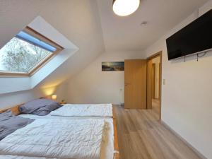 Ένα ή περισσότερα κρεβάτια σε δωμάτιο στο Komfortferienhaus Deichzauber Norddeich