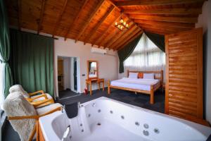 a bathroom with a tub and a bedroom with a bed at Asil Villas in Sapanca