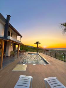 a house with a swimming pool with a sunset at Asil Villas in Sapanca +20 photos
