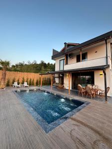 a house with a swimming pool in front of a house at Asil Villas in Sapanca