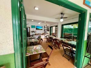 a restaurant with tables and chairs in a room at Pousada Arraial Caribe in Arraial do Cabo