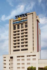 a building with a sign on the top of it at Krishna Palace Hotel in Mumbai