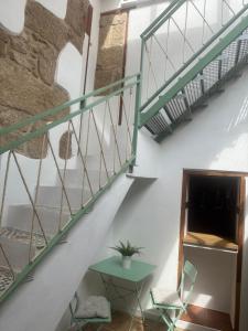 a staircase in a room with a table and chairs at Casita La Mercería in Güimar