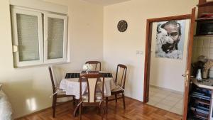 a dining room with a table and some chairs at Mathilda's Apartment in Španjola +7 photos