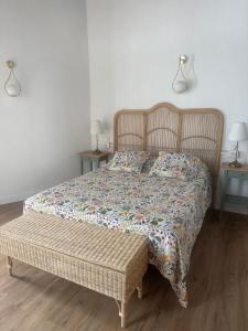 a bed in a bedroom with two tables and two lamps at Casita La Mercería in Güimar